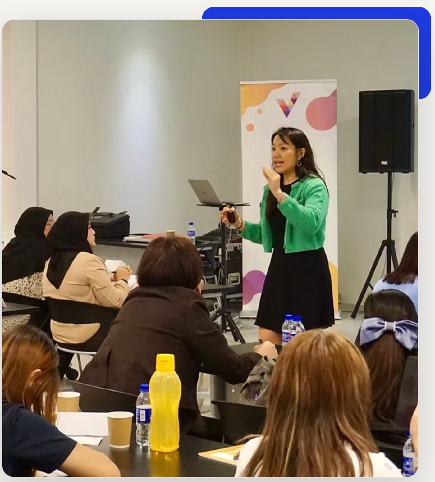 Stephanie Lam leading a marketing workshop at the front of a training room