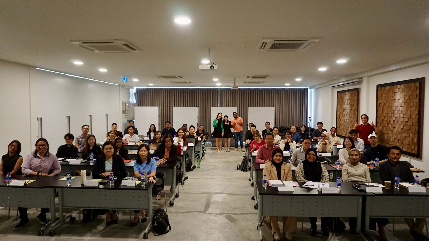 Hotel function room filled with seated workshop participants