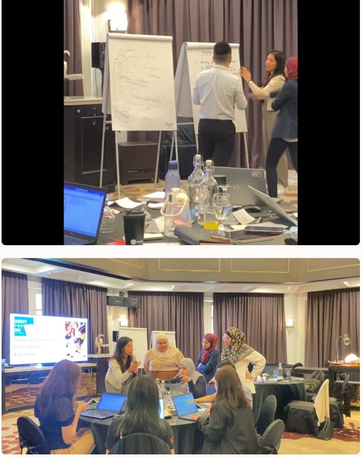 Participants at laptops in a hotel training room during a hands-on build session