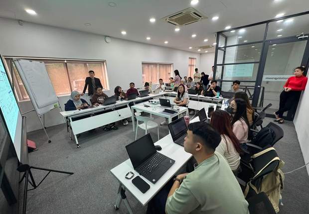 Participants working on laptops during a hands-on workshop module