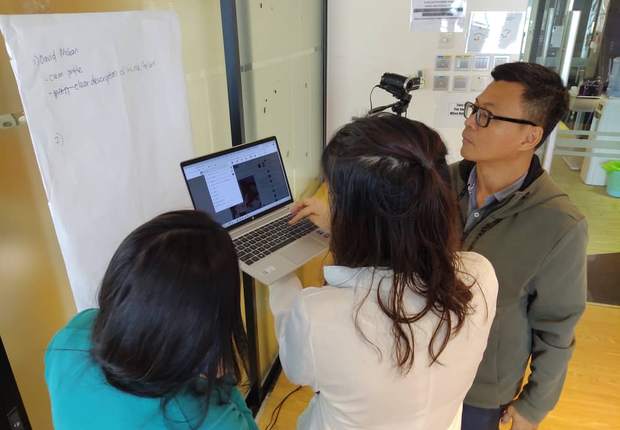 Close coaching with participants at a laptop during an exercise