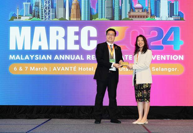 Stephanie Lam receiving recognition on stage at MAREC 2024, the Malaysian Annual Real Estate Convention